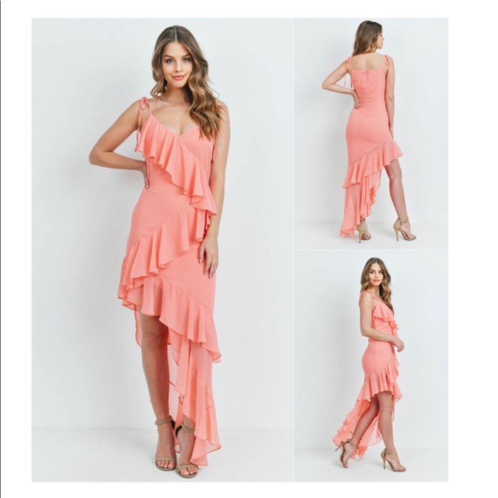 Coral dress with tie straps and an asymmetrical ruffle going down the middle
